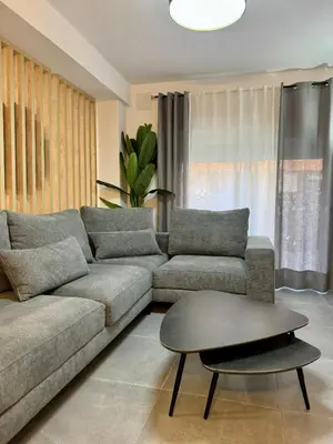 a living room with a couch and a coffee table at Apartamento Guadalquivir 34 in Sanlúcar de Barrameda