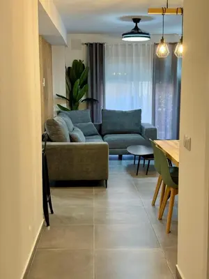 a living room with a couch and a table at Apartamento Guadalquivir 34 in Sanlúcar de Barrameda