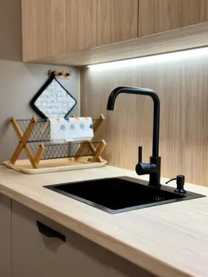 a kitchen counter with a black sink in a kitchen at Apartamento Guadalquivir 34 in Sanlúcar de Barrameda