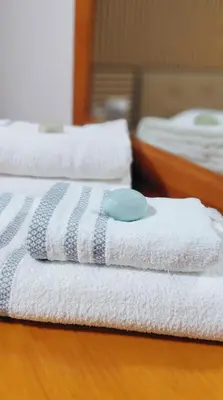 two white towels with a blue ball on top of them at Villa Caheta in Chipiona