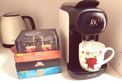 a coffee maker sitting next to a box and a cup at Villa Caheta in Chipiona