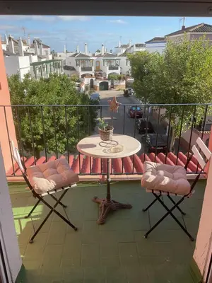 a balcony with a table and chairs on a balcony at Casa Marejada in Puerto Real