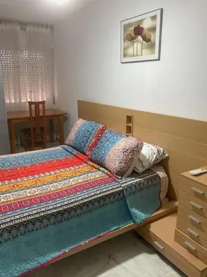 a bedroom with a bed with a quilt on it at Casa Marejada in Puerto Real