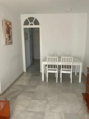 a dining room with a white table and two chairs at Casa Marejada in Puerto Real