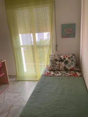 a bedroom with a bed and a large window at Casa Marejada in Puerto Real