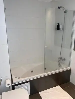 a bathroom with a shower and a bath tub at Refugio del Atlántico in El Puerto de Santa María
