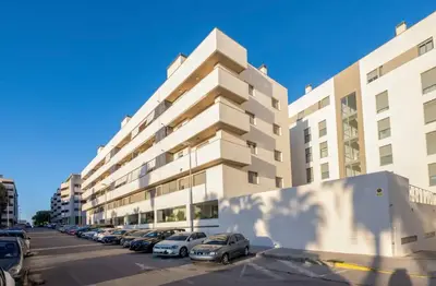 a parking lot in front of a large building at Refugio del Atlántico in El Puerto de Santa María