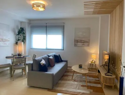a living room with a couch and a table at Refugio del Atlántico in El Puerto de Santa María