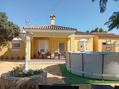 a yellow house with a hot tub in the yard at Casa SUROESTE - Zona El Colorado, Conil de la Frontera in Roche