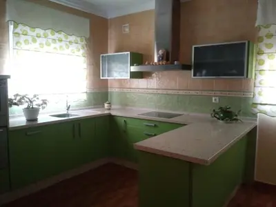 a kitchen with green cabinets and a sink and a window at Casa SUROESTE - Zona El Colorado, Conil de la Frontera in Roche