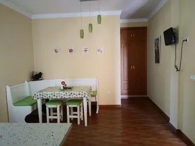 a dining room with a table and green chairs at Casa SUROESTE - Zona El Colorado, Conil de la Frontera in Roche