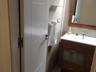 a bathroom with a sink and a cabinet with a mirror at Cádiz Un respiro en Cádiz in Cádiz