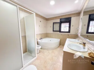 a bathroom with a tub and a toilet and a sink at Villa Cañuela in Chiclana de la Frontera
