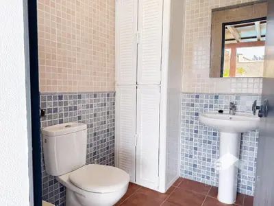 a bathroom with a toilet and a sink at Villa Cañuela in Chiclana de la Frontera