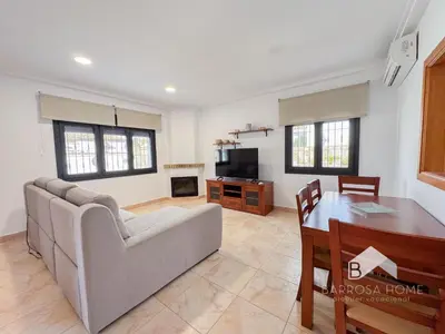 a living room with a couch and a table at Villa Cañuela in Chiclana de la Frontera