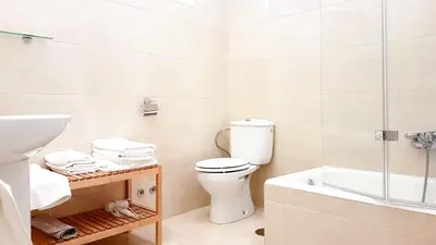 a bathroom with a toilet and a sink and a tub at Casa Palacio Morla y Melgarejo in Jerez de la Frontera
