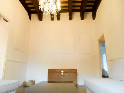 a living room with a table and a chandelier at Casa Palacio Morla y Melgarejo in Jerez de la Frontera