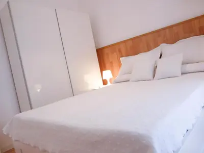 a bedroom with a white bed with white pillows at Casa Palacio Morla y Melgarejo in Jerez de la Frontera