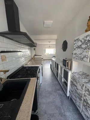 a kitchen with a stove top oven in a room at Churruca 3 Preferentemente para familias y mayores de 25 años in El Puerto de Santa María