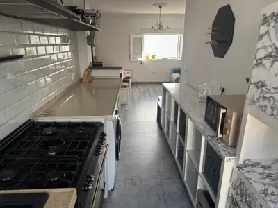 a kitchen with a stove and a counter top at Churruca 3 Preferentemente para familias y mayores de 25 años in El Puerto de Santa María