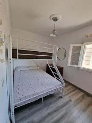 a bedroom with a white bunk bed in a room at Churruca 3 Preferentemente para familias y mayores de 25 años in El Puerto de Santa María