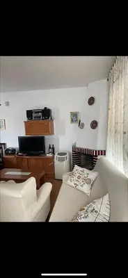 a living room with two white chairs and a couch at villa los gallos 10 in Chiclana de la Frontera