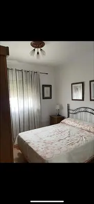 a bedroom with a bed and a ceiling fan at villa los gallos 10 in Chiclana de la Frontera