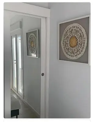 a room with two pictures on the wall and a door at Villa ELY in Chiclana de la Frontera