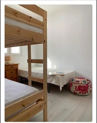 a bedroom with two bunk beds and a desk at Villa ELY in Chiclana de la Frontera