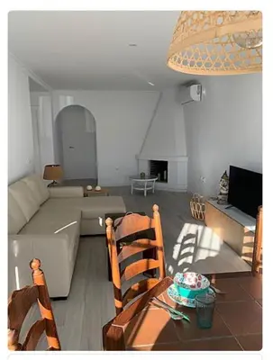 a living room with a couch and a table at Villa ELY in Chiclana de la Frontera