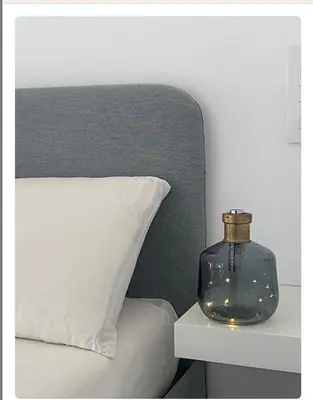 a glass jar sitting on a table next to a bed at Villa ELY in Chiclana de la Frontera