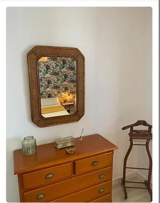 a mirror on top of a dresser in a room at Villa ELY in Chiclana de la Frontera