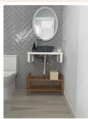 a bathroom with a sink and a mirror at Villa ELY in Chiclana de la Frontera