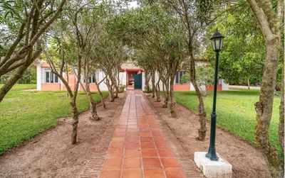 a walkway in a park with trees and a street light at Family country house with pool in Conil in Cádiz