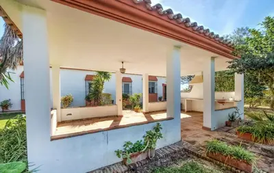 an exterior view of a house with plants at Family country house with pool in Conil in Cádiz