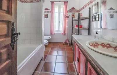 a bathroom with a tub and a sink and a toilet at Family country house with pool in Conil in Cádiz