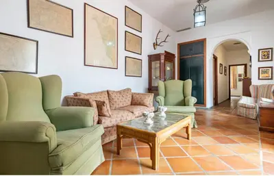 a living room with two couches and a coffee table at Family country house with pool in Conil in Cádiz