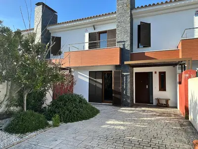 a white house with a balcony and a driveway at Casa de playa nueva y luminosa in Chiclana de la Frontera