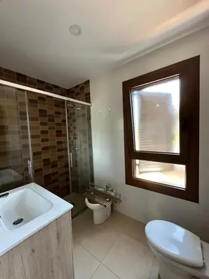 a bathroom with a sink and a toilet and a window at Casa de playa nueva y luminosa in Chiclana de la Frontera