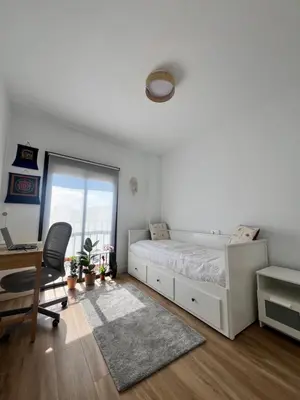 a bedroom with a bed and a desk and a window at GATU Rubí in El Puerto de Santa María