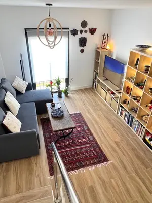 a living room with a couch and a table at GATU Rubí in El Puerto de Santa María