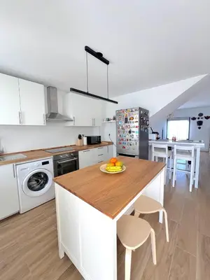 a kitchen with a counter with a plate of fruit on it at GATU Rubí in El Puerto de Santa María