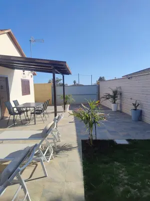 a patio with chairs and a table at CASA Marimonte in Conil de la Frontera