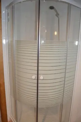a shower stall with a glass door in a bathroom at CASA Marimonte in Conil de la Frontera