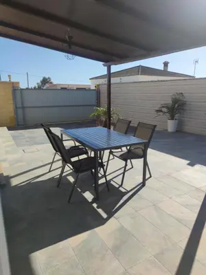a blue table and chairs on a patio at CASA Marimonte in Conil de la Frontera