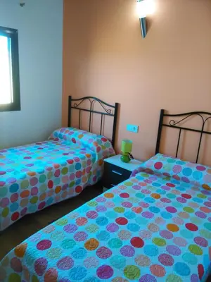 two beds sitting next to each other in a room at CASA Marimonte in Conil de la Frontera