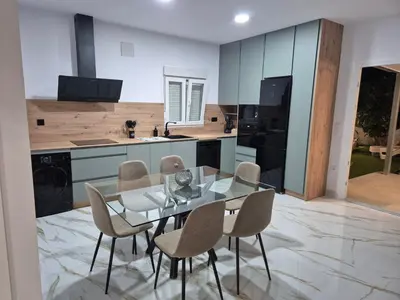 a kitchen with a glass table and chairs at Casitalola in Conil de la Frontera