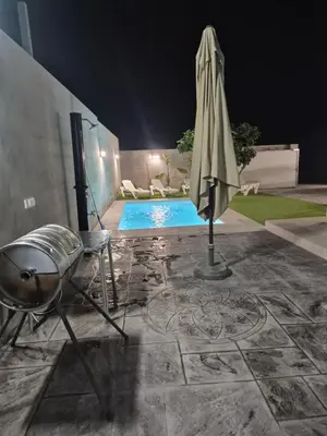 a patio with an umbrella next to a pool at Casitalola in Conil de la Frontera