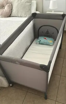 a bed frame with a pillow on top of it at Apto cerca de playa Regla con garaje in Chipiona
