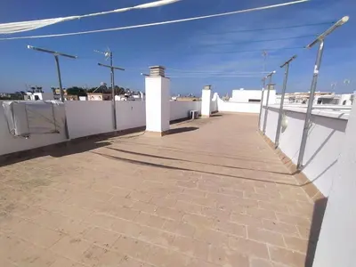a walkway on top of a house with a white fence at Apto cerca de playa Regla con garaje in Chipiona